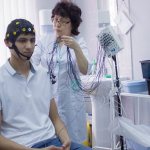 What does an EEG of the brain show in adults?