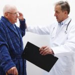врач осматривает пациента с «мушками» перед глазами